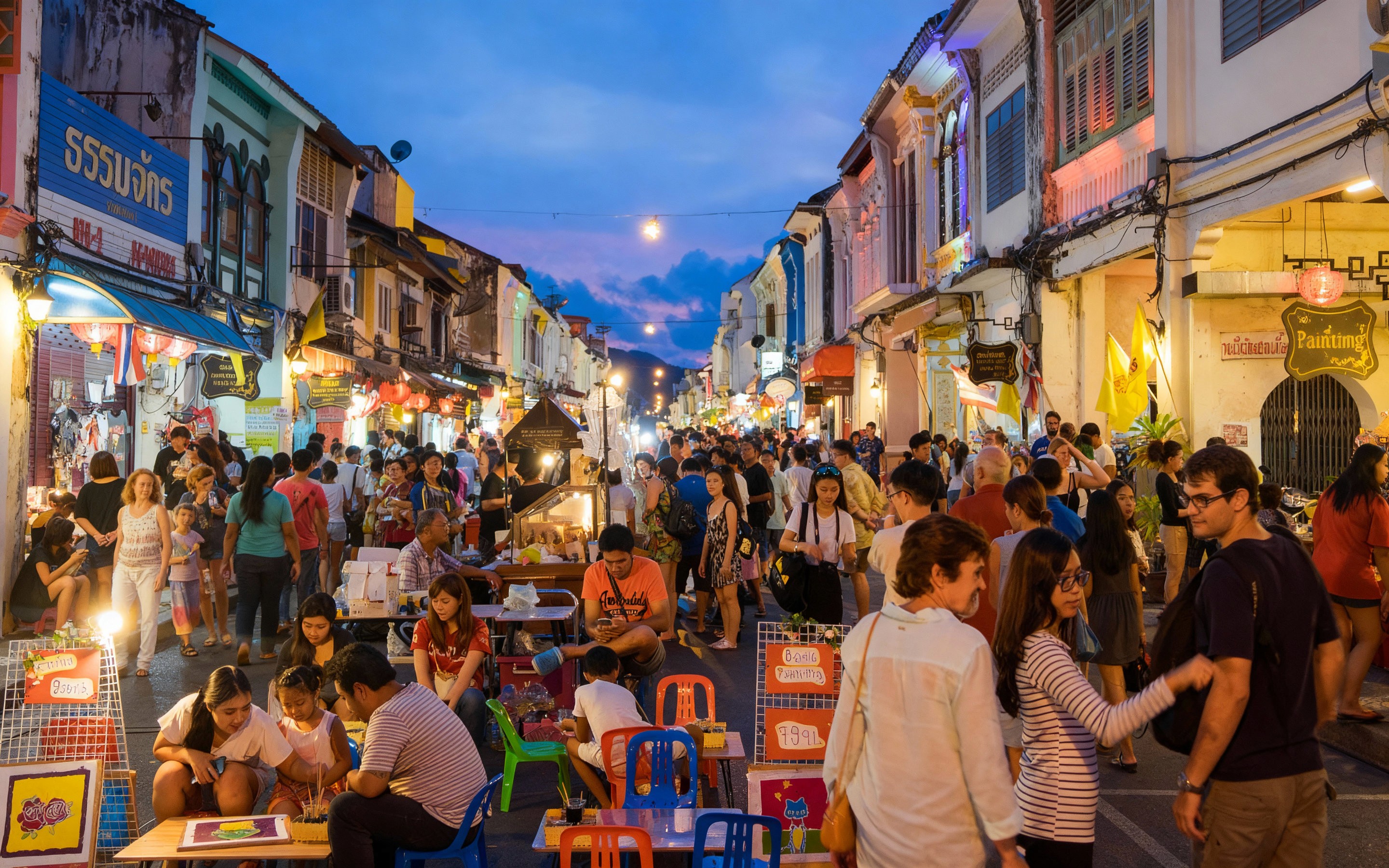 Bustling evening scene at Chiang Mai’s Walking Street Market with crowds exploring colorful stalls, local crafts, and food vendors along a lively street lined with old shop-houses under a twilight sky.