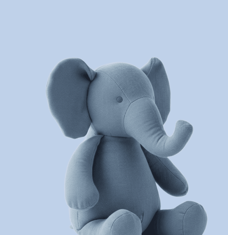 A medium-sized grey cotton elephant stuffed animal with floppy ears and a trunk.