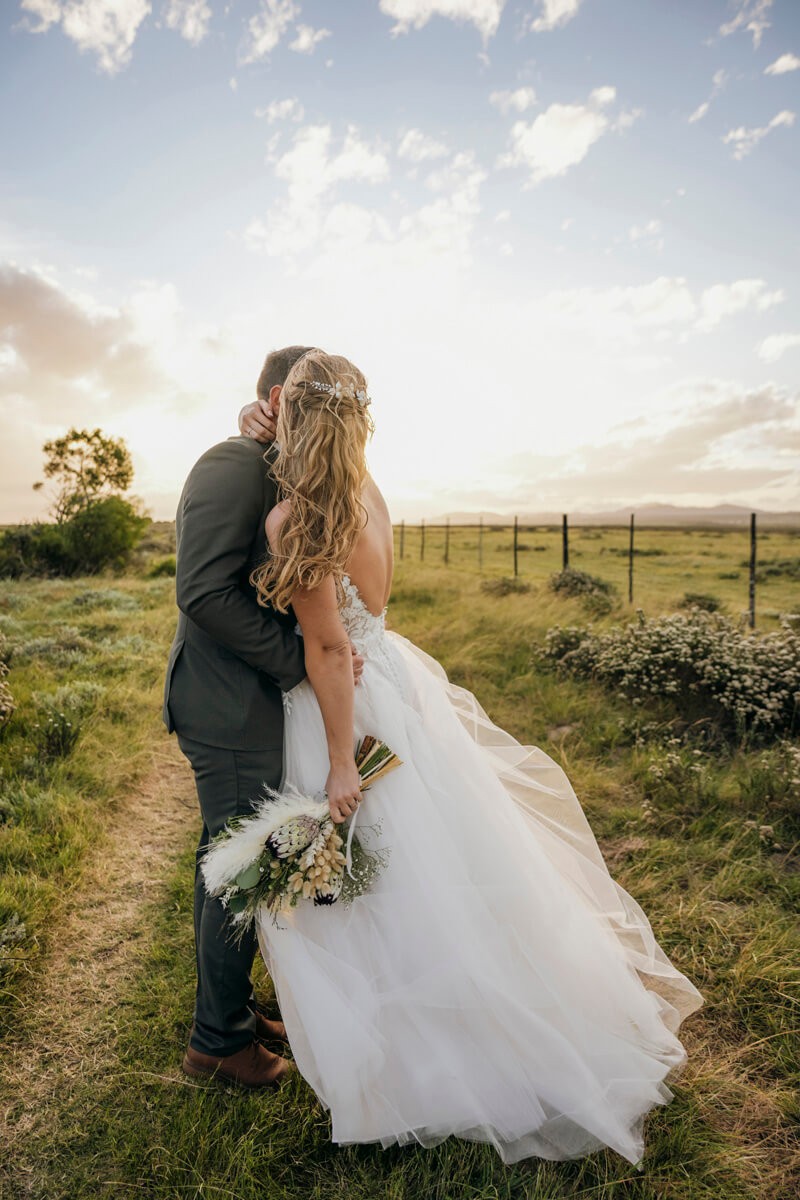 Romantic couple portrait highlighting bridal bouquet at Lombardini