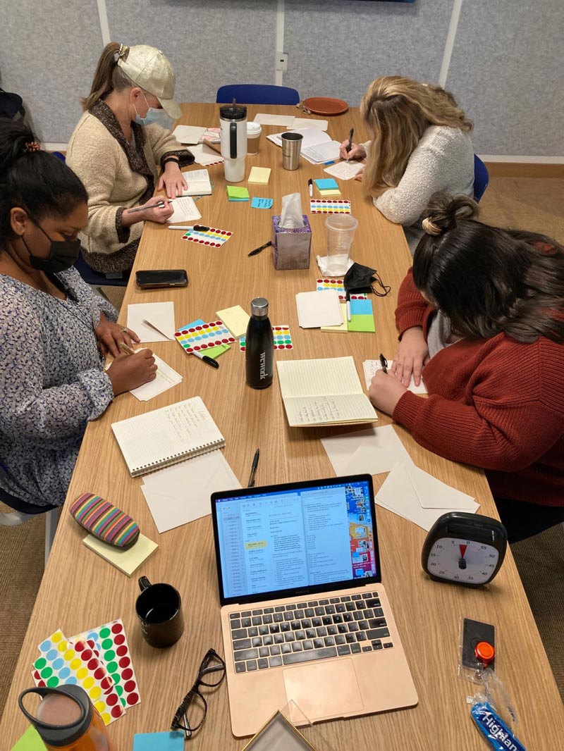 A group of people sitting around a conference table during a workshop