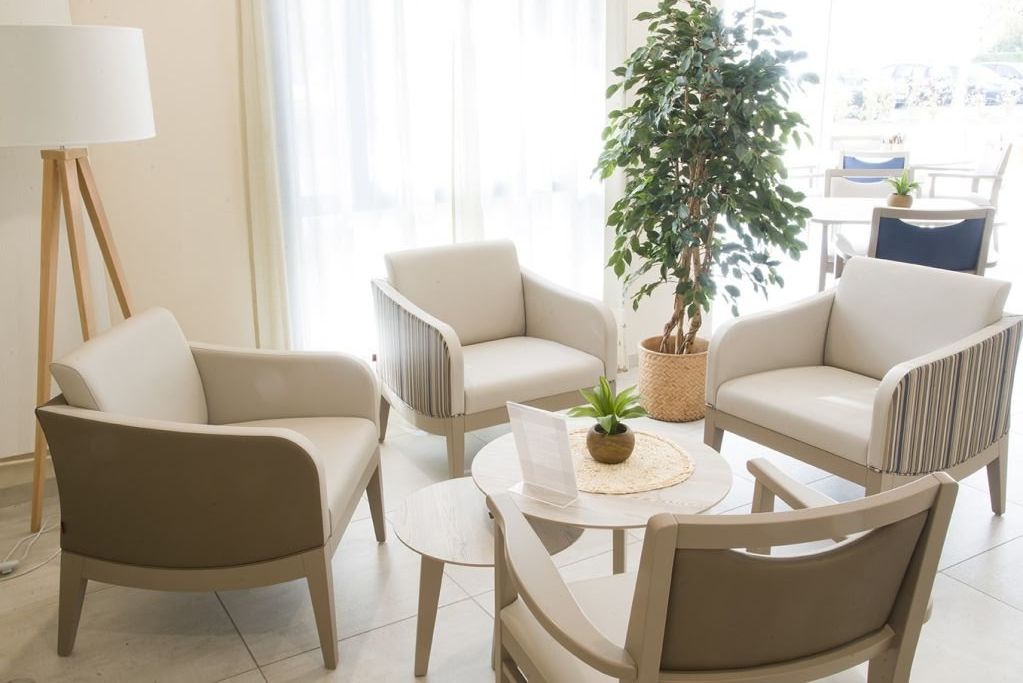 Living room with comfortable seating	television	shelving units	and warm color scheme