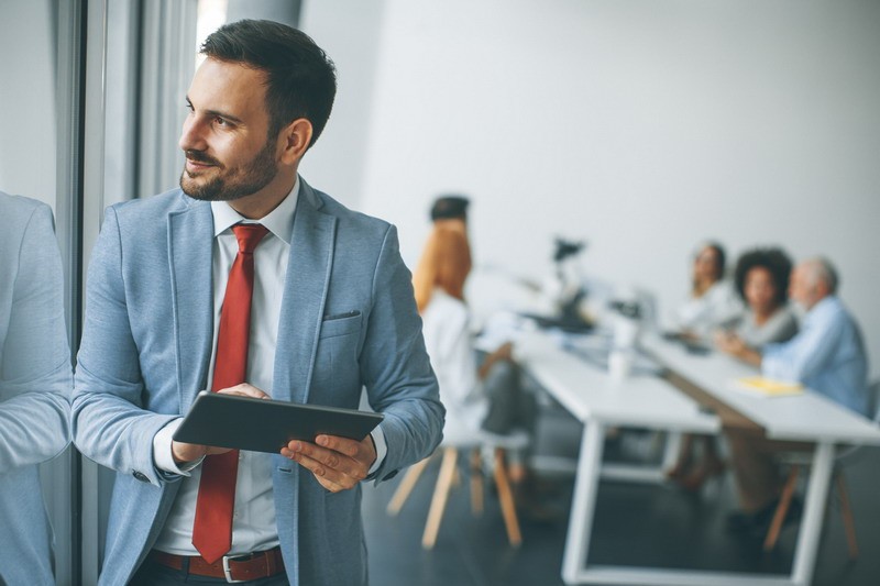 Young businessman with digital tablet in office