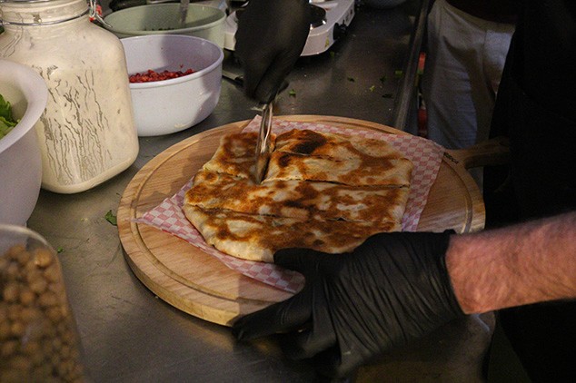 a chef cutting an egyptian feteer