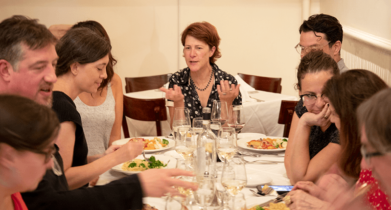 people chatting while they are having dinner at a restaurant