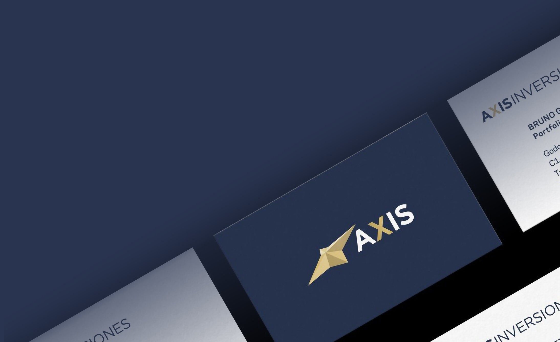 Business cards on a dark blue background. Central card features a gold, geometric logo and "AXIS" text, conveying professionalism and elegance.
