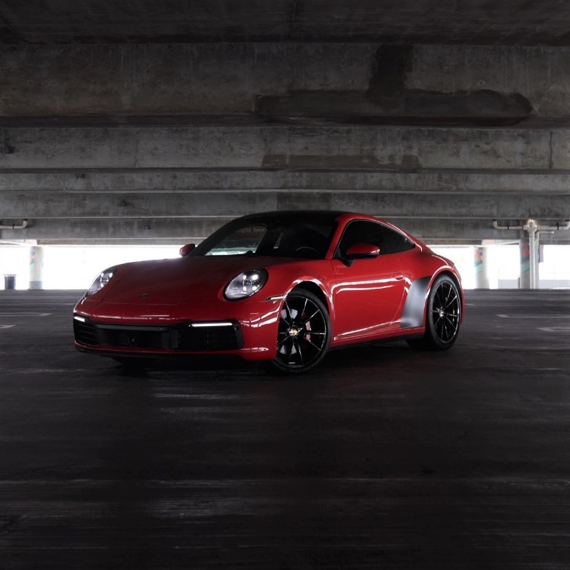 Stunning silver Porsche 911 Carrera S parked in a luxurious Miami setting with palm trees – perfect for exotic car rental Miami.