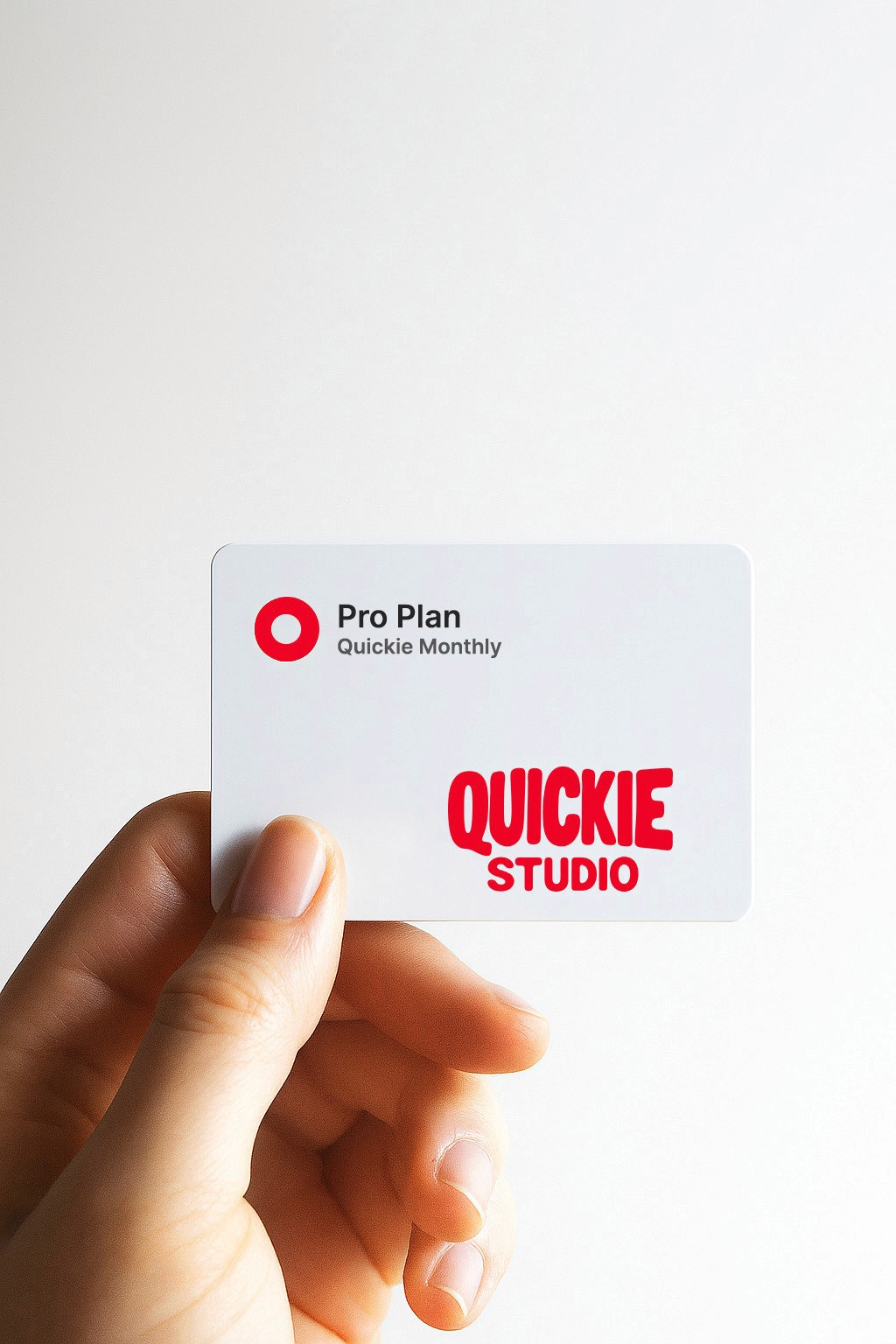 Hand holding a Quickie Studio Pro Plan membership card, representing fast, professional creative services available through Quickie’s monthly plan.