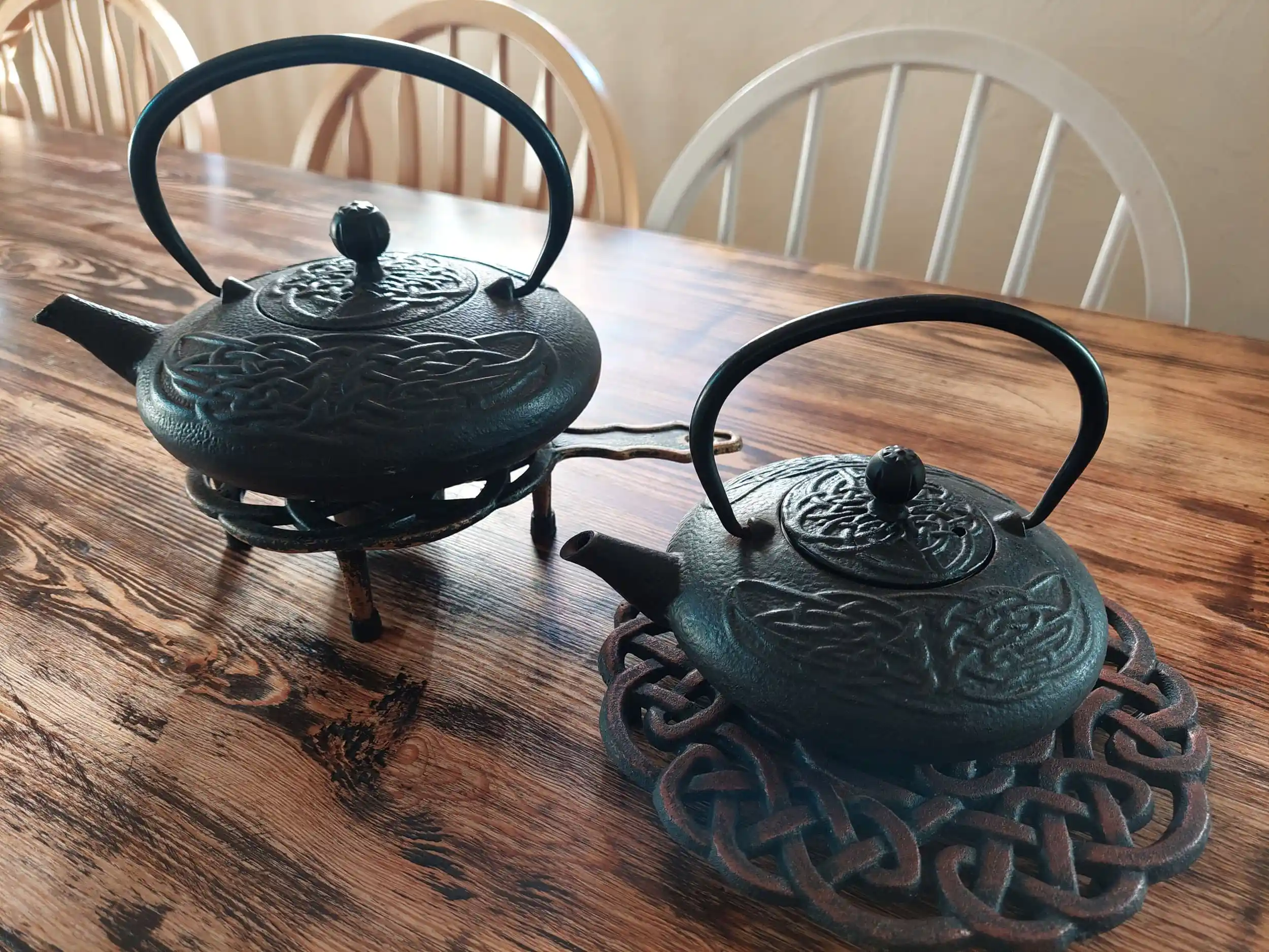 Cast-iron teapots on table inside