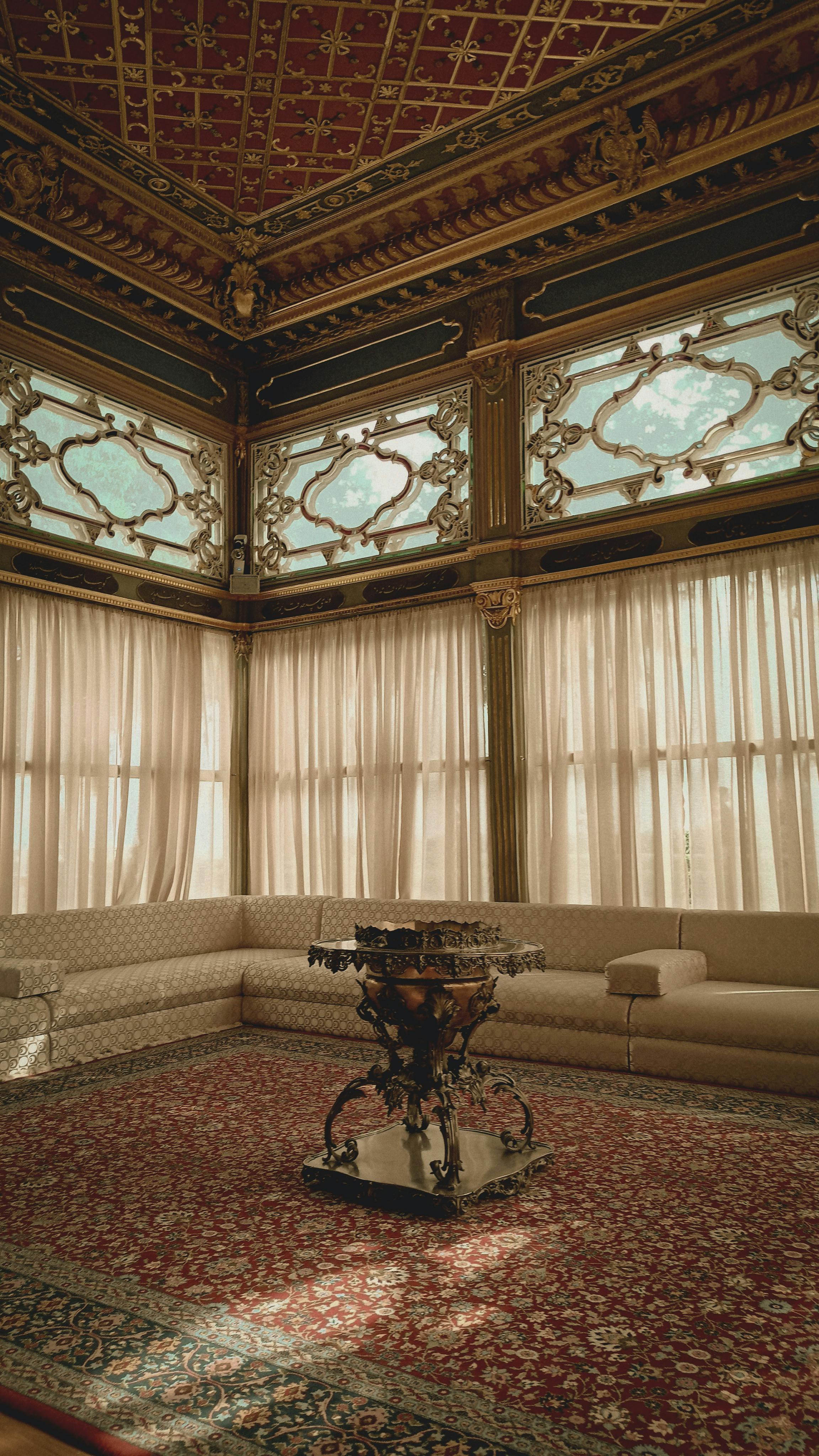 Traditional carpeted stairs ascending with candle-like wall stands and classic interior styling.