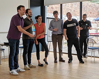 Six people lined up on stage receiving an award