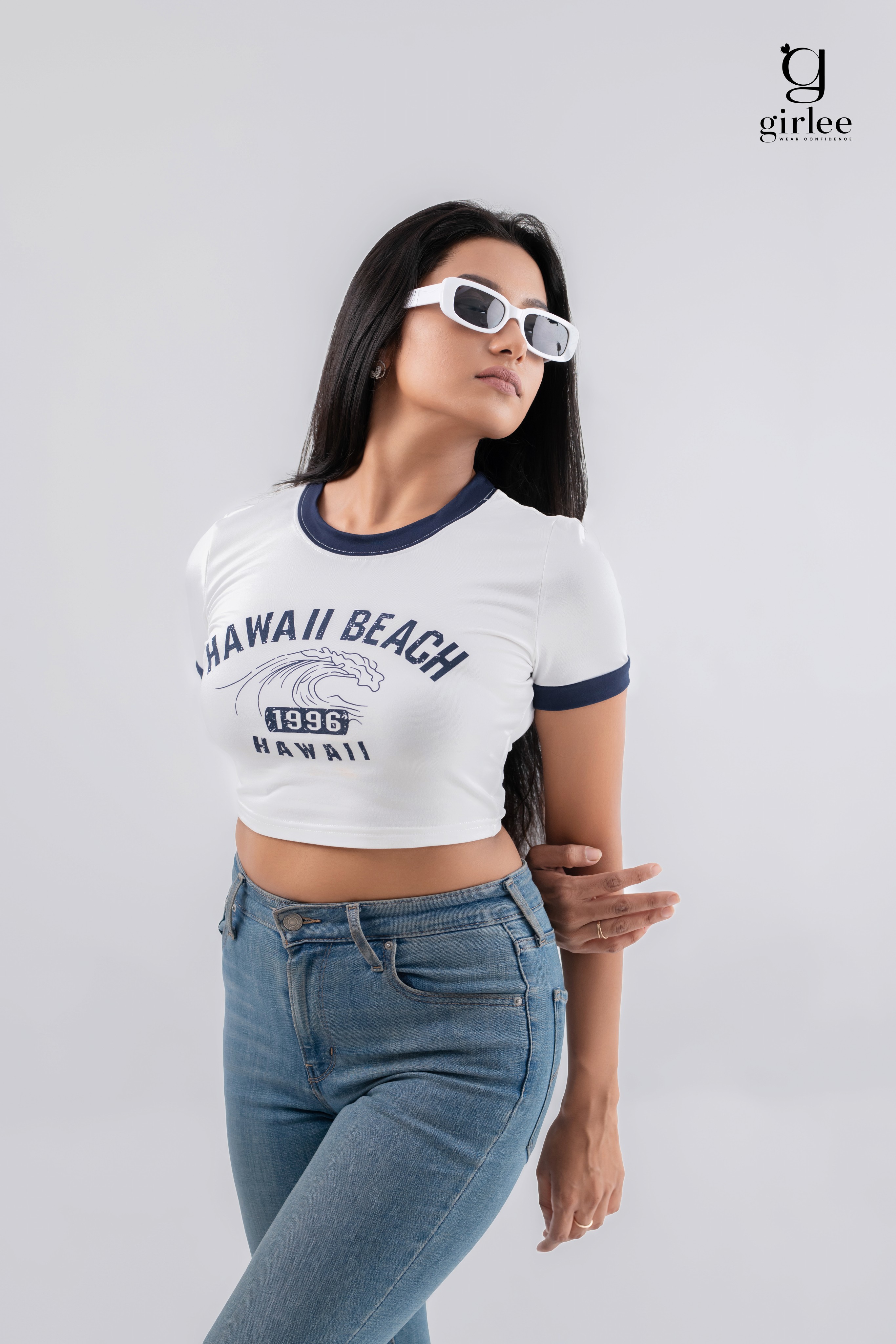 Close-up of a dark green leaf showing its textured surface and central vein against a muted background.