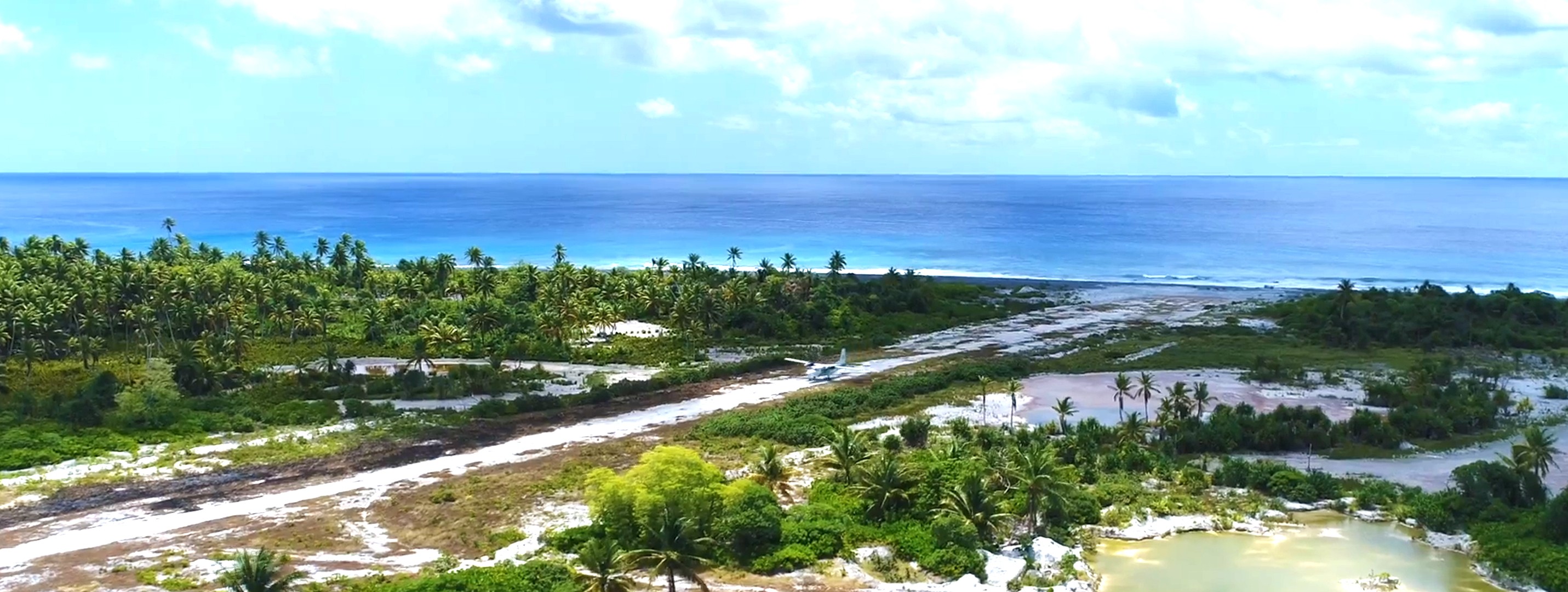 woman holding a phone and man looking at the phone. both are smiling