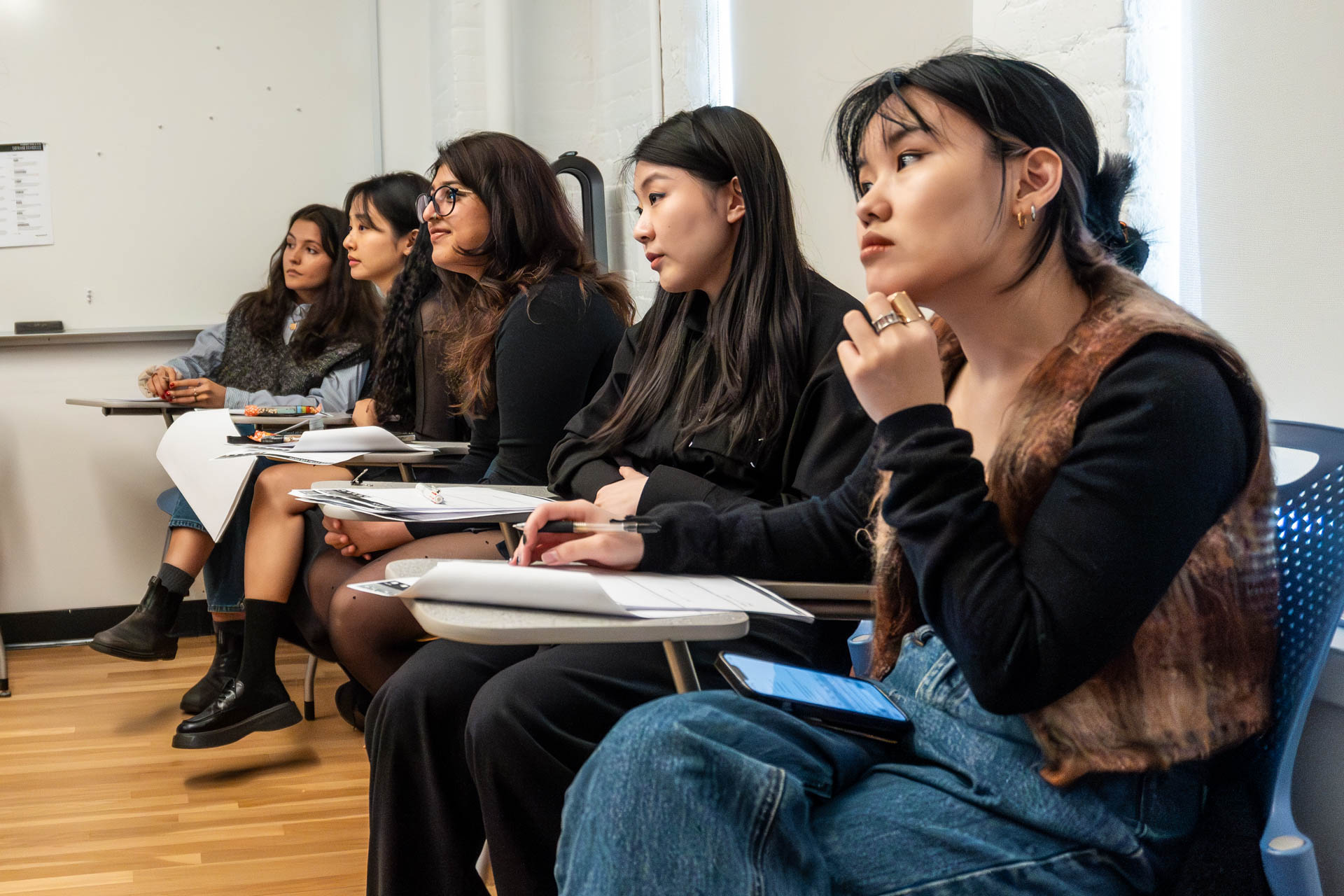 students listening to a classmate giving a presentation