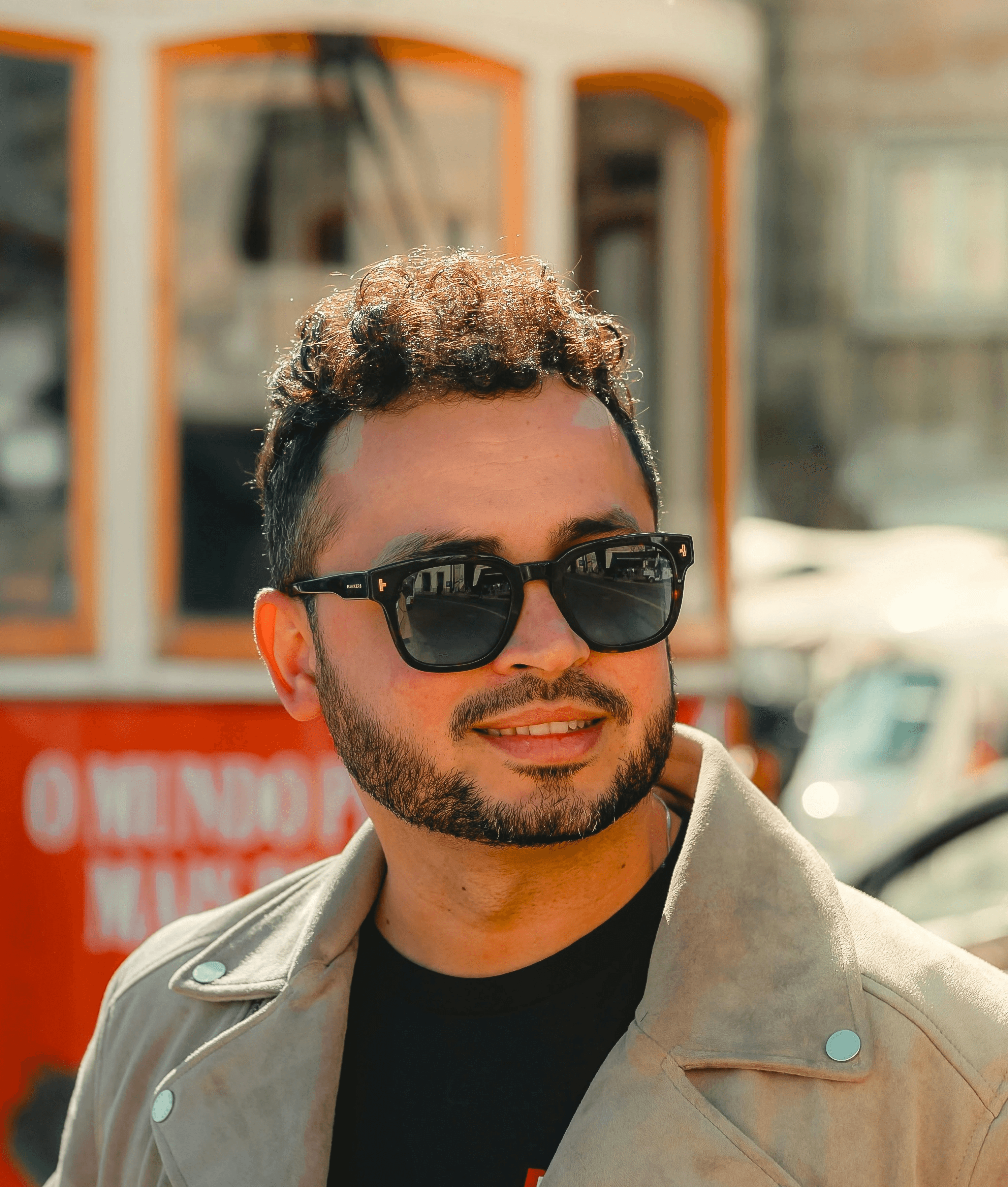 A man standing in front of a trolley on a street