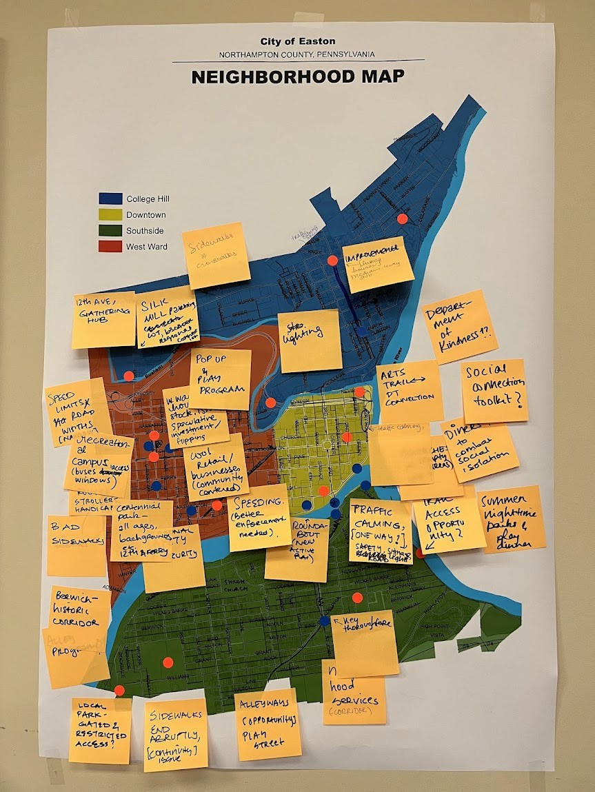 Modern home office setup with a monitor, ergonomic chair, keyboard, and indoor plants near a window with blinds.