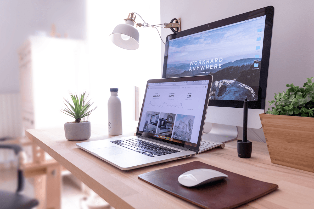 Laptop and desktop setup showing website design work