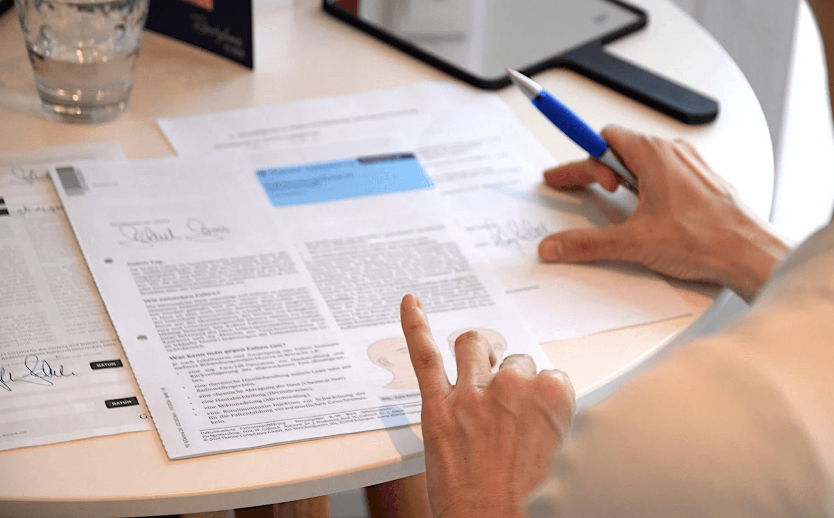 Heilpraktikerin füllt in der Praxis einen Fragebogen für eine Labordiagnostik aus.