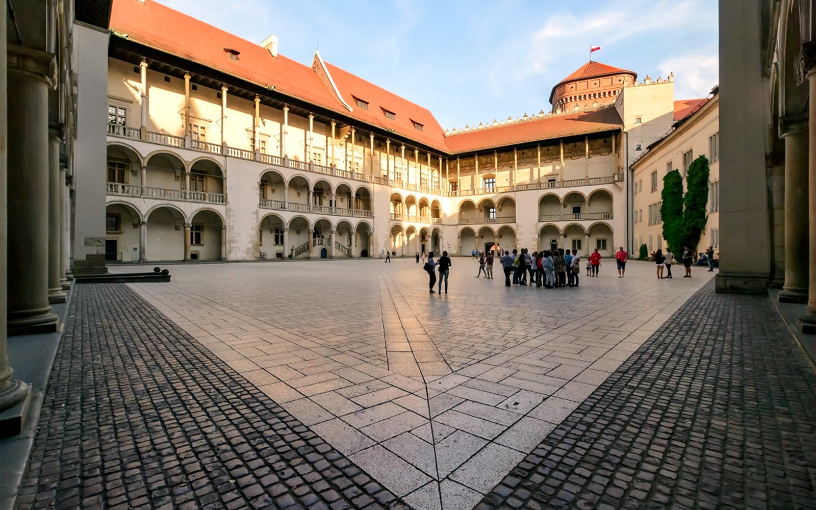 Wawel Castle courtyard with a group of tourists, Krakow, Poland.