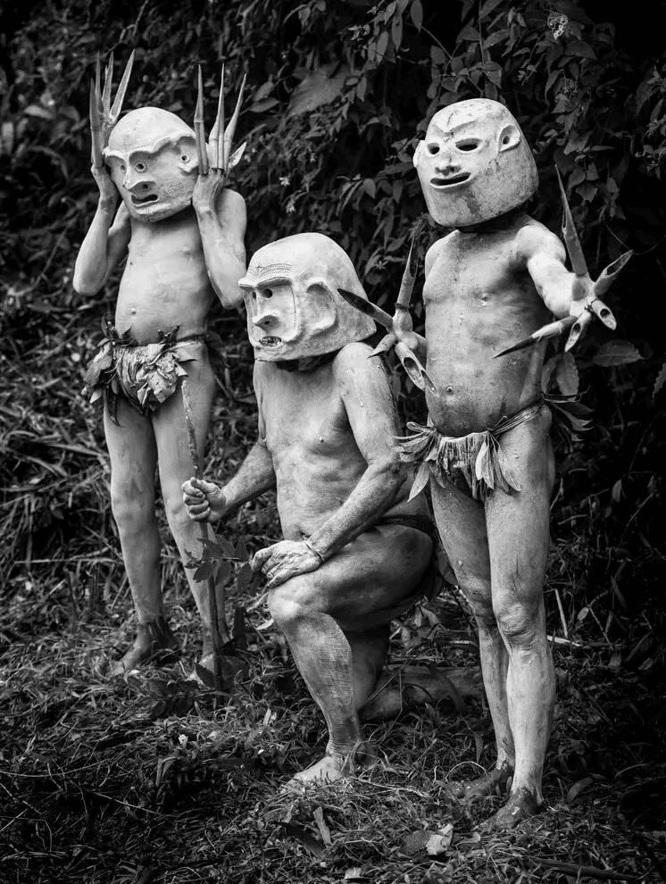 Papua New Guinea highlands tribal performers wearing traditional masks during cultural ceremony