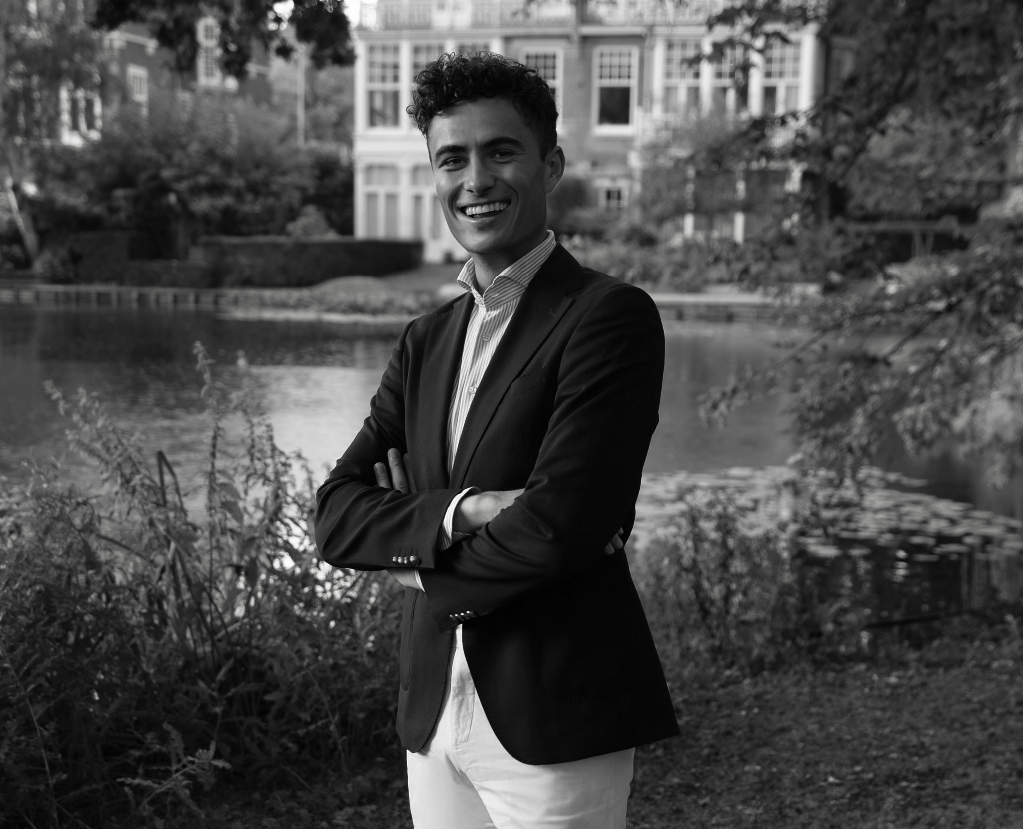 Portrait of a person in a pink sweater against a light background