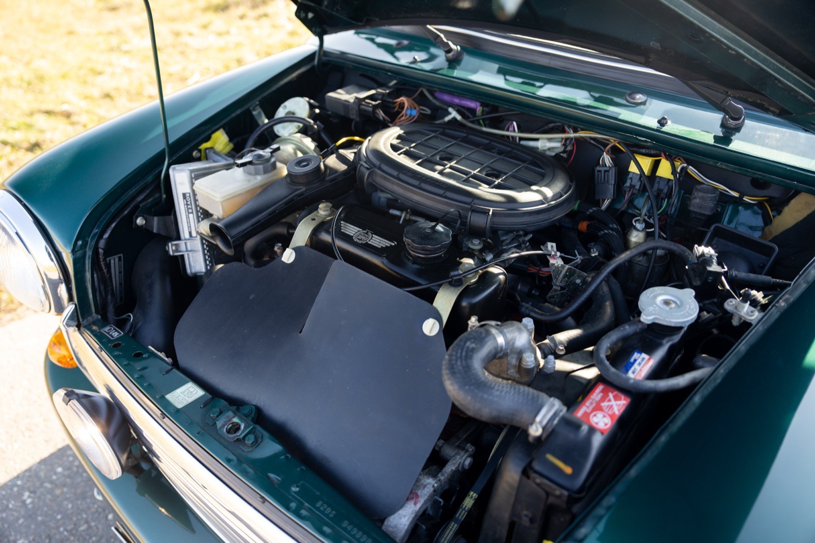 An engine compartment with various mechanical components visible, featuring a shiny, well-maintained engine.
