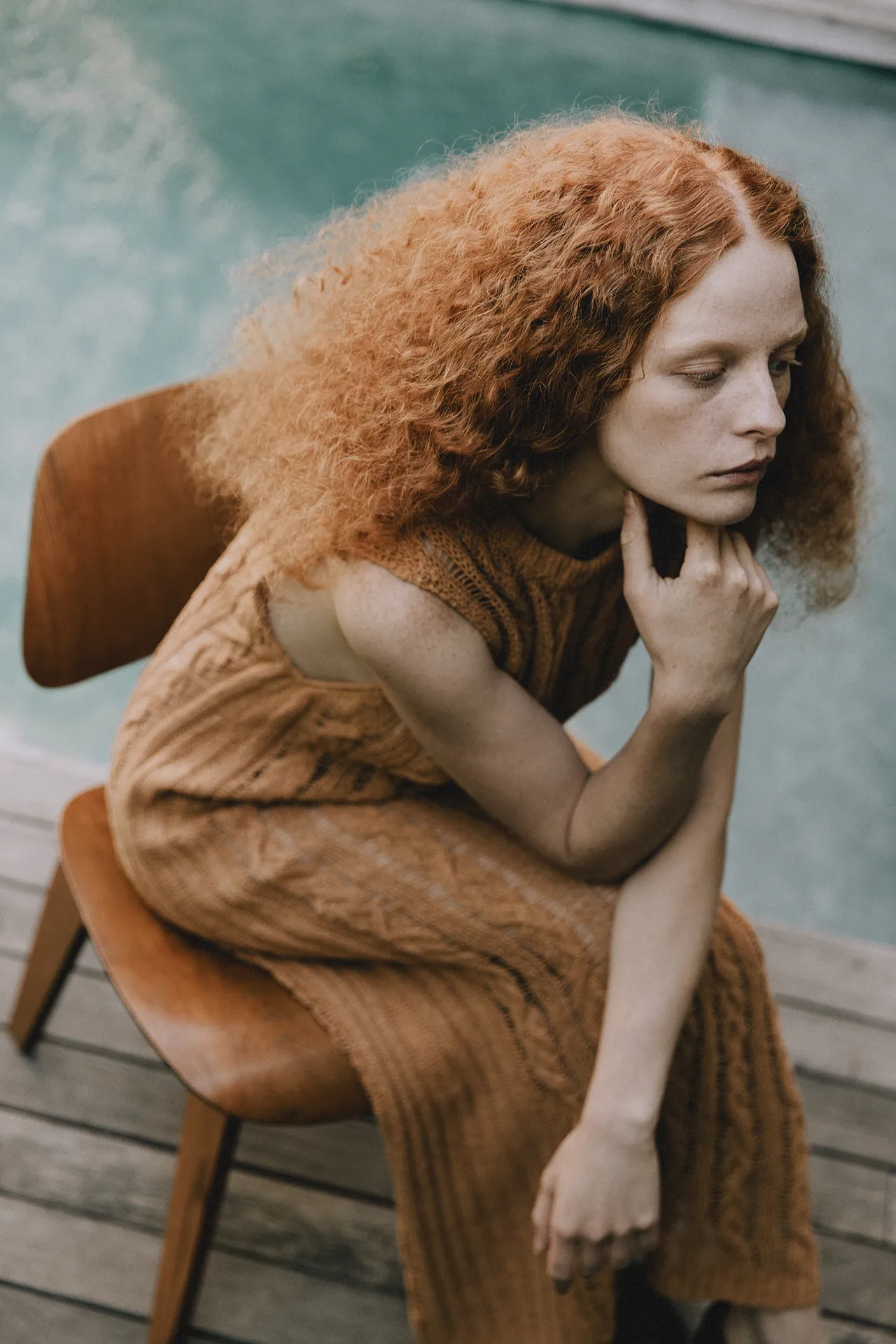 Annapurna SS26 collection orange sleeveless cable knit dress featuring intricate openwork details worn by a model.