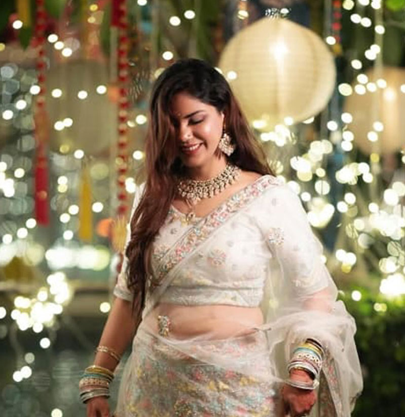 A close-up image showcasing a pair of elegant high heels with a glossy finish and intricate embellishments, paired with sparkling jewelry.