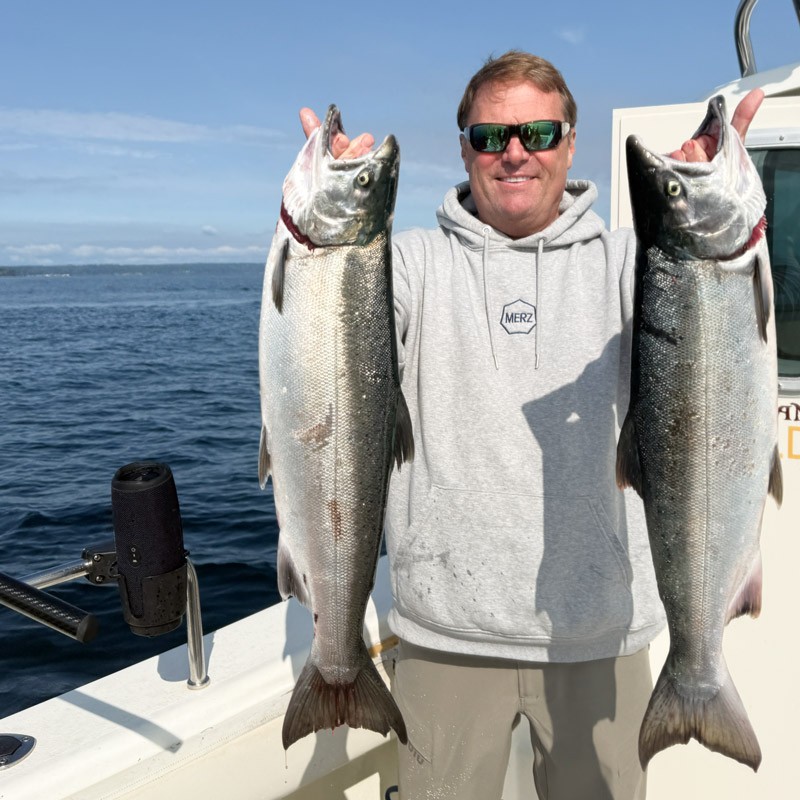 Man holding trophy coho salmon