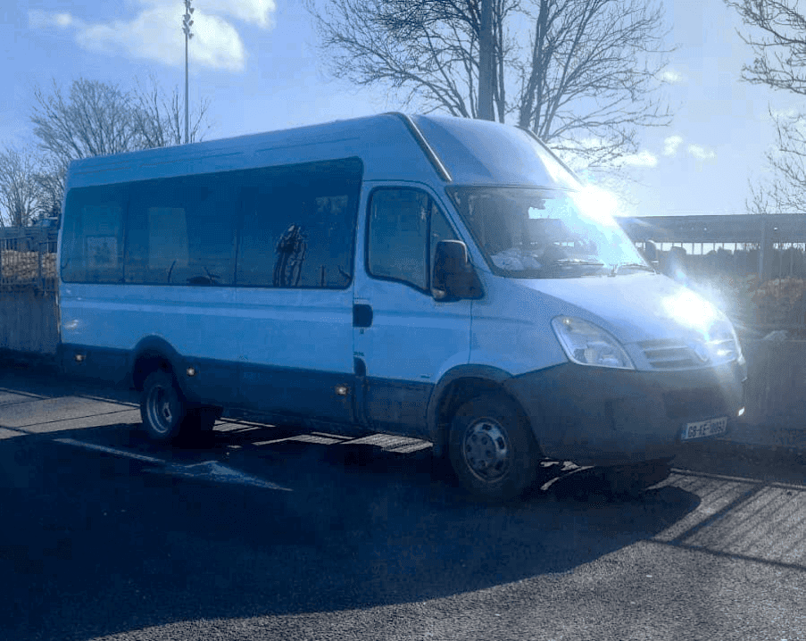 AOK Bus Hire parked outside on a sunny day