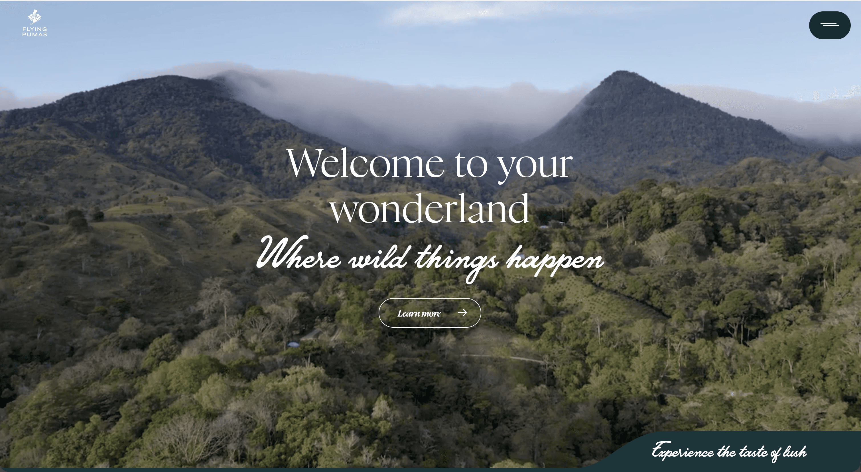 woman siting with coffie in her hand and the young men is standing looking at the camera