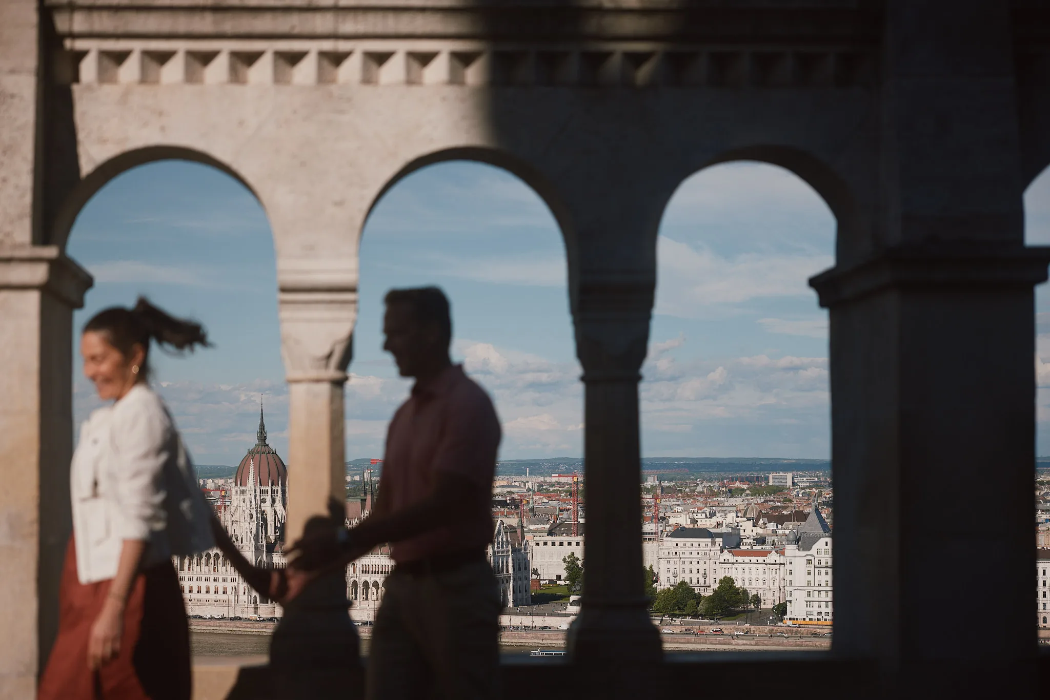 couple walking hand in hand at fishermans bastion — lifestyle photography by Tom Kubik