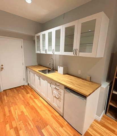 Finished IKEA kitchenette assembly and installation with cabinets, countertop, and sink.
