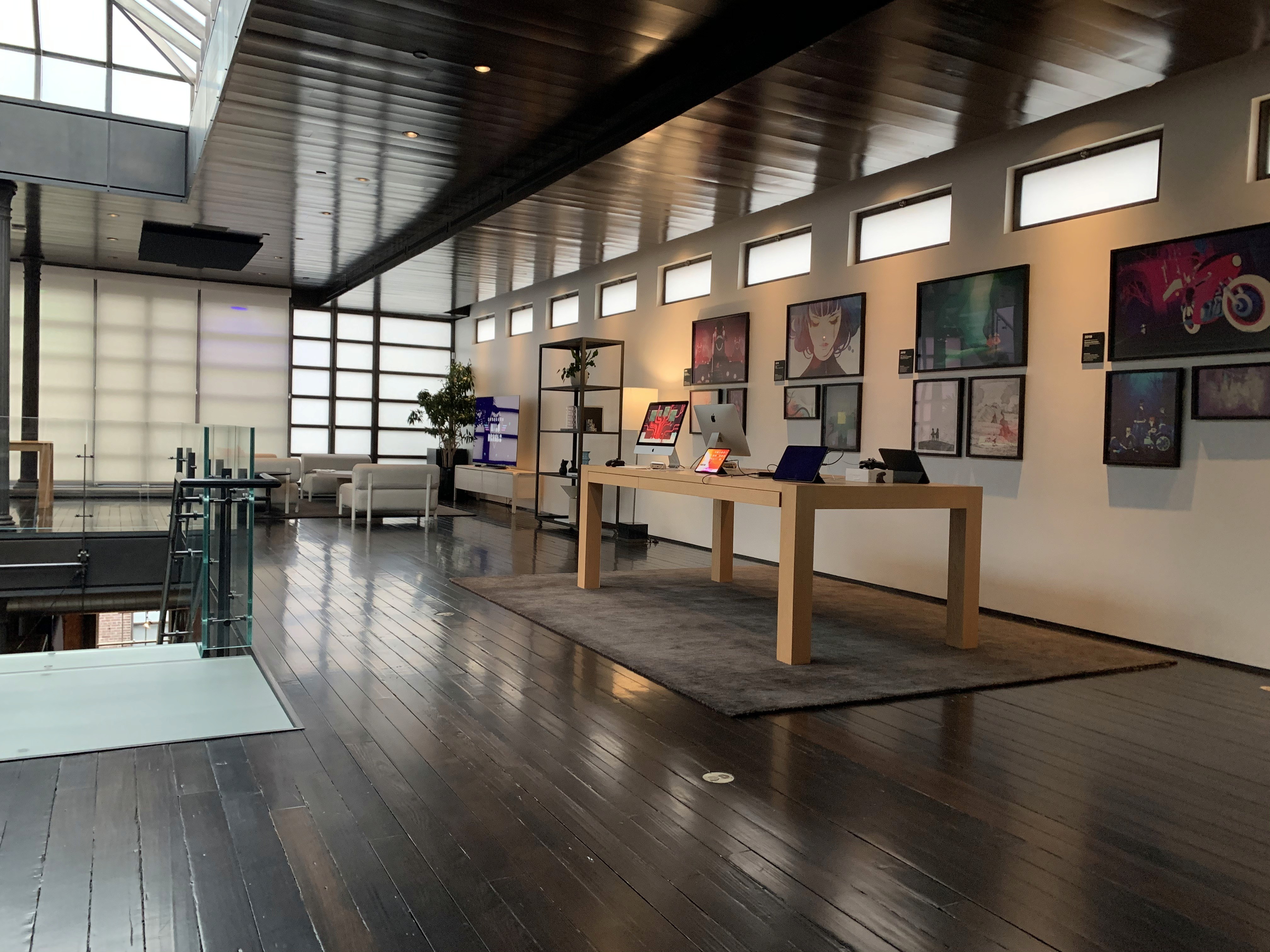 Modern retail-style interior with product tables and wall displays, photographed in a clean, open space.