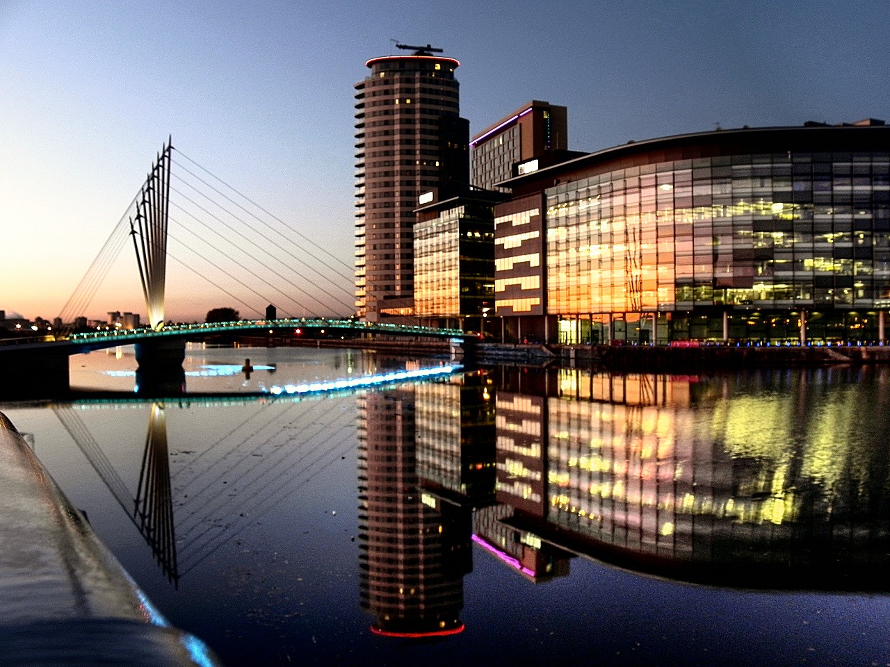 Aerial view of MediaCityUK waterfront at dusk, reflecting the vibrant Manchester tech ecosystem Datacentreplus operates within