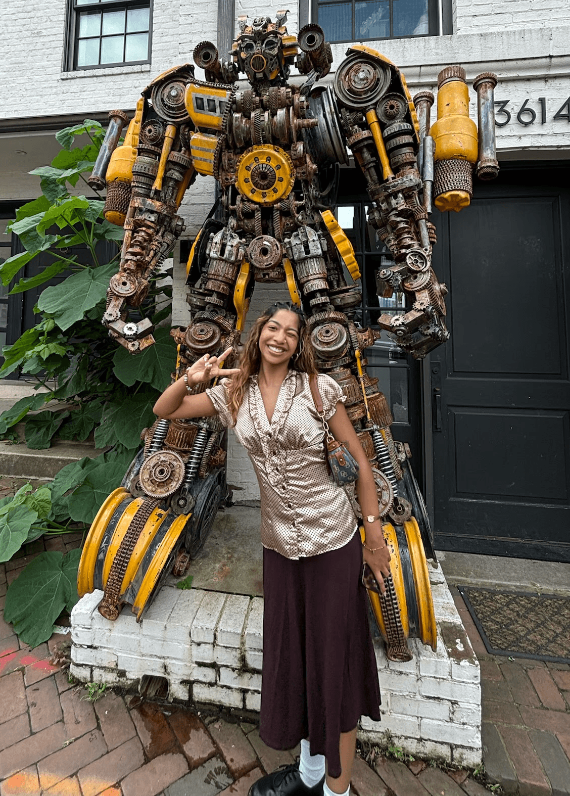Girl posing in front of a statue