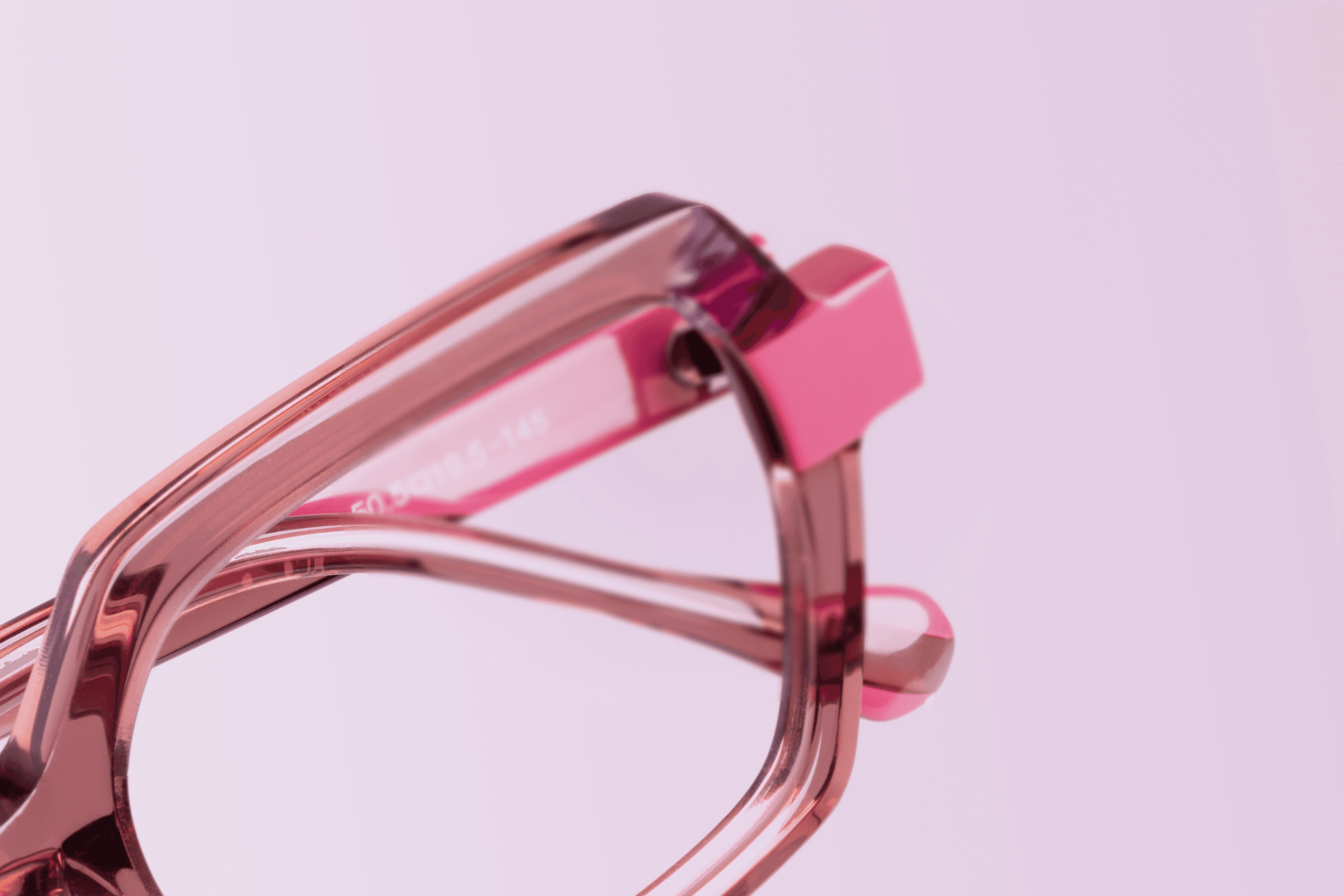 A close-up of a beige-colored laptop with a smooth, matte finish on a matching surface.