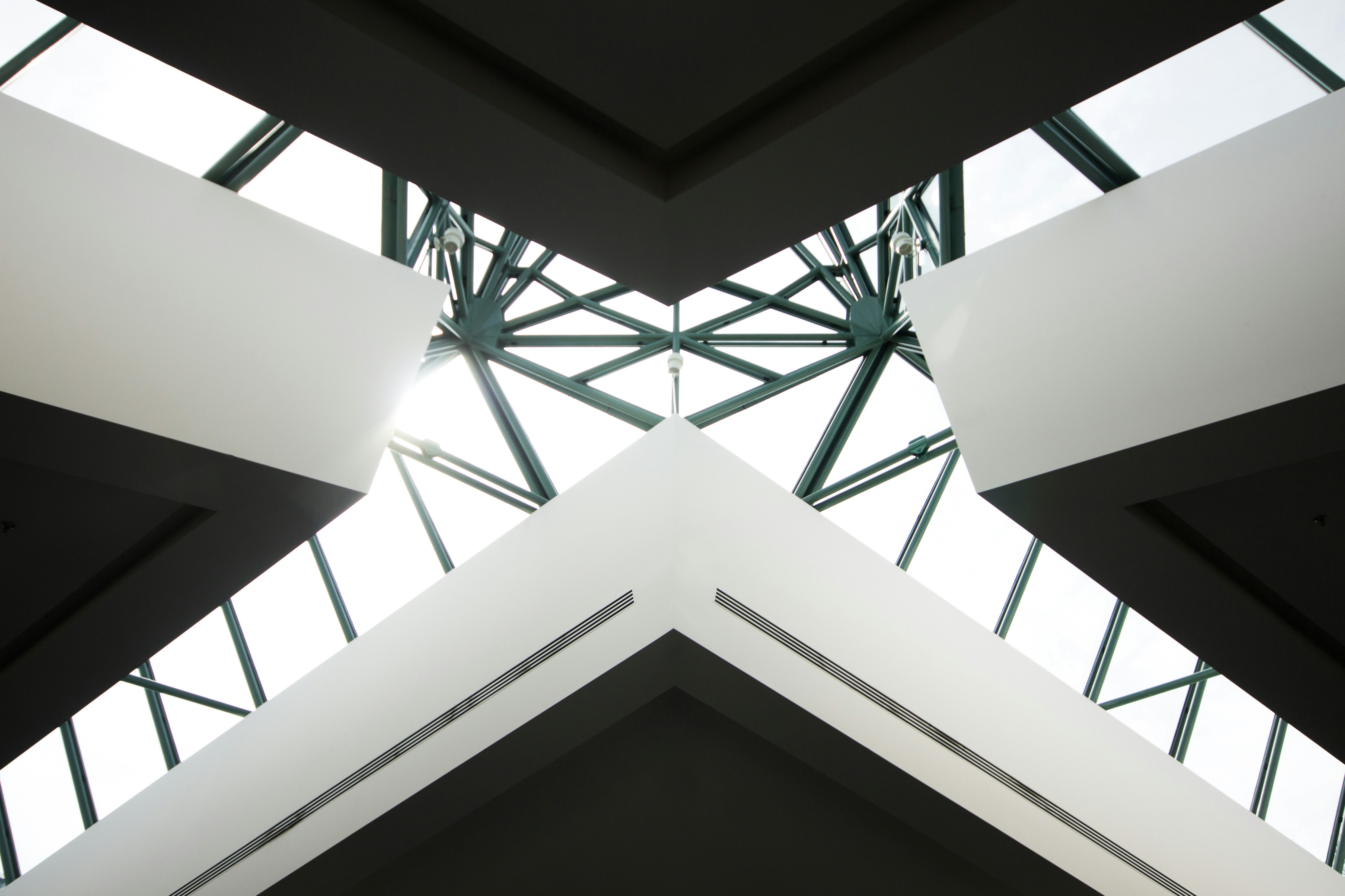 An upward looking image of a building meeting to show the outer scaffolding in an X shape