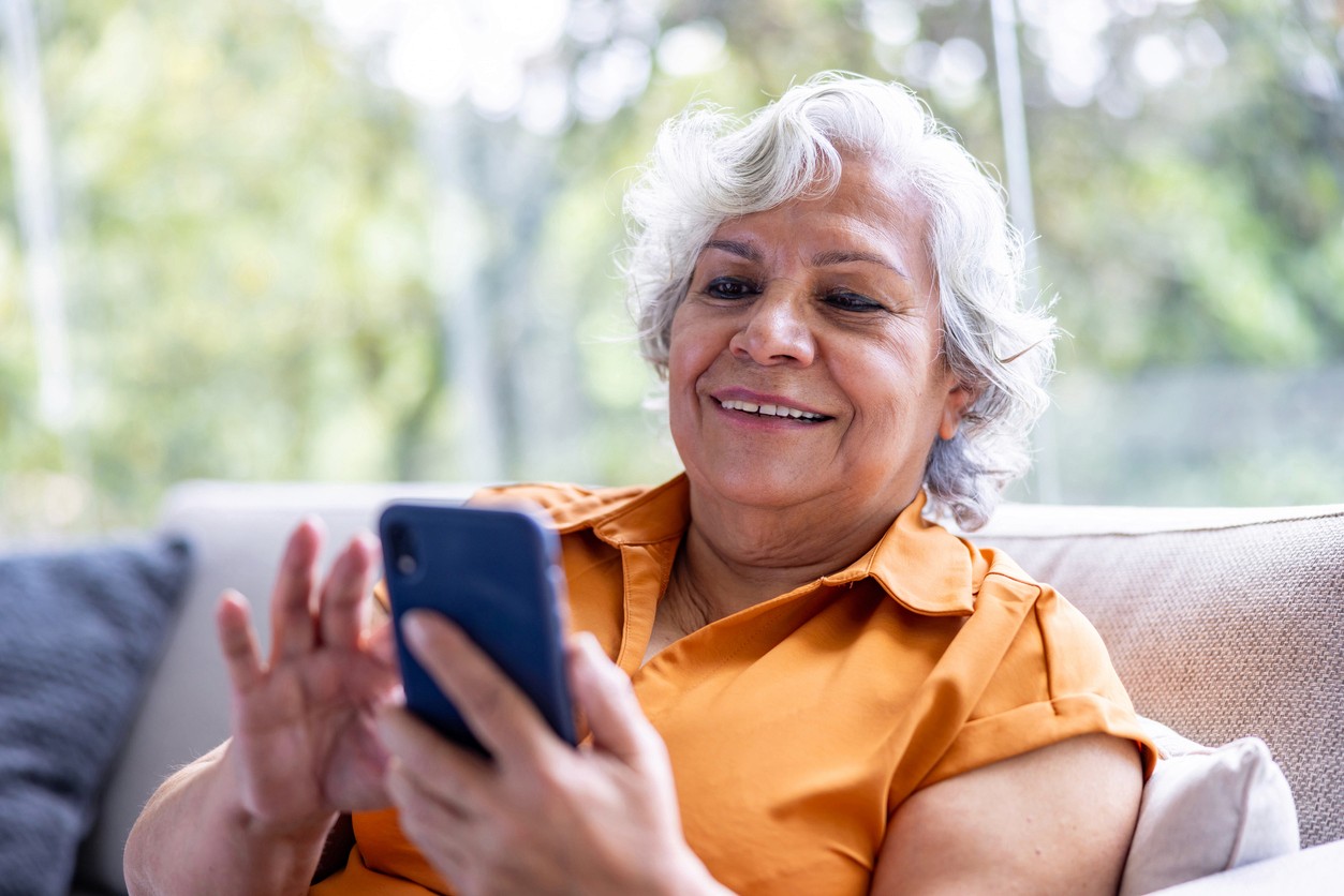 Senior woman searching for care on smart phone