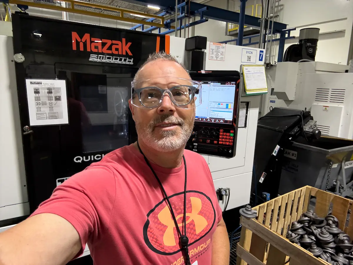 Stu standing in from of his CNC machine beginning his shift at Reliable Sprinkler Company.