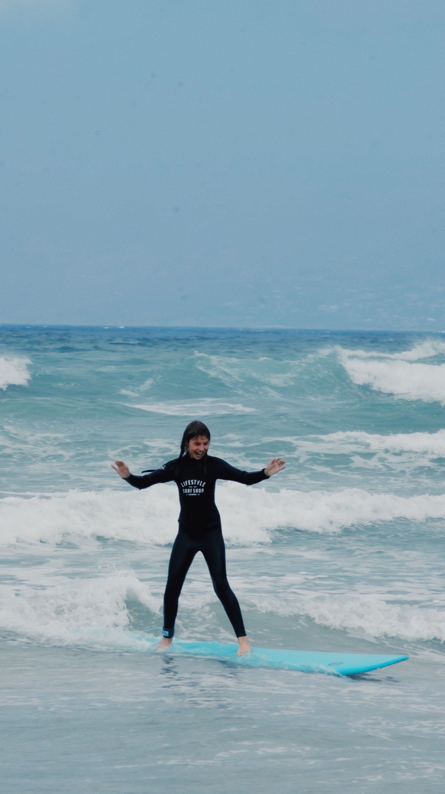 A kid enjoying her beginner surf lesson for kids in Cape Town, Muizenberg