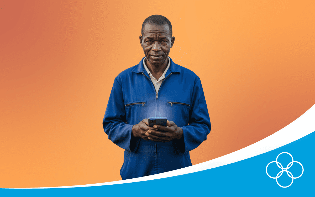 African poultry farmer in a blue overall, holding a phone