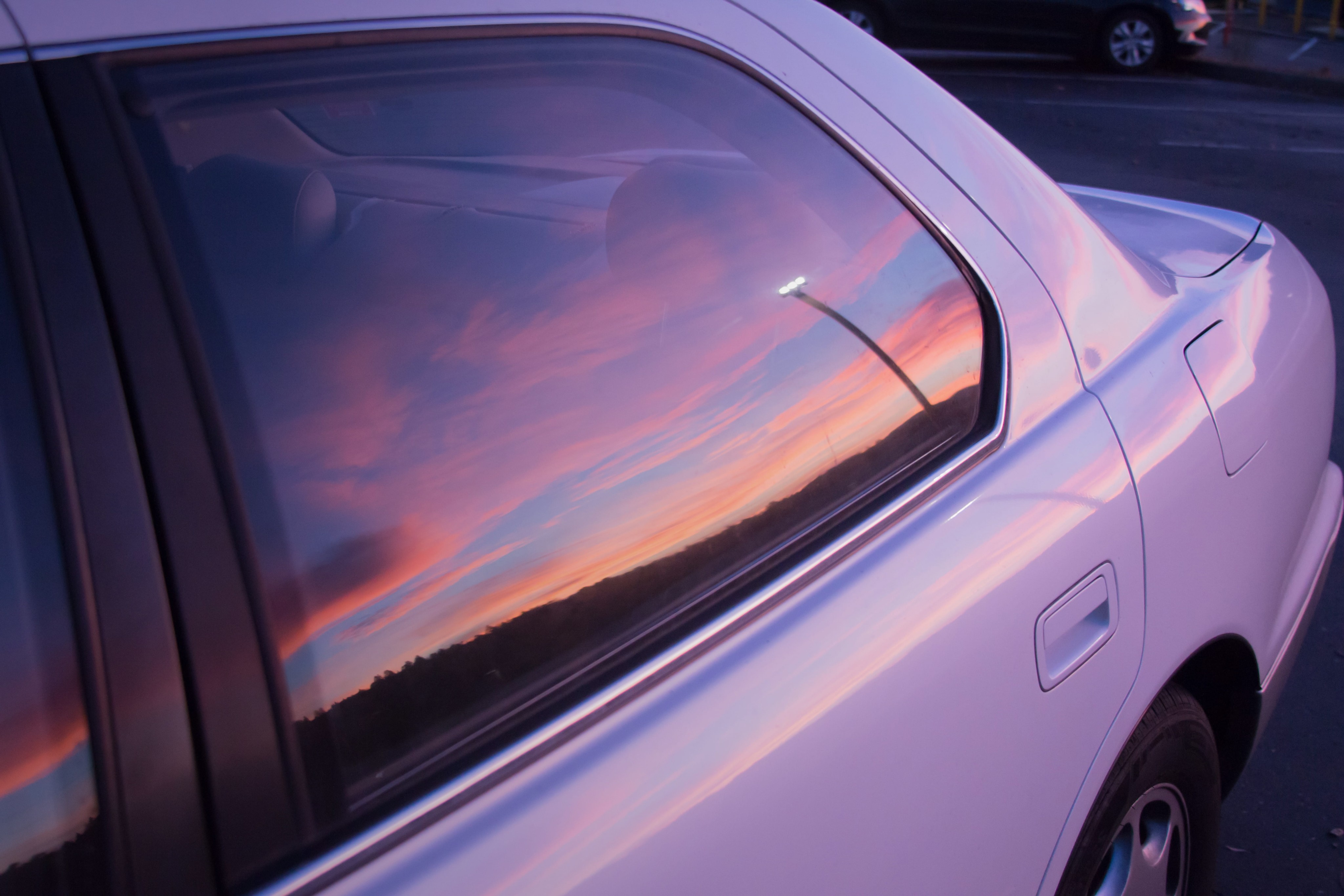 Car window with a sunset view reflection