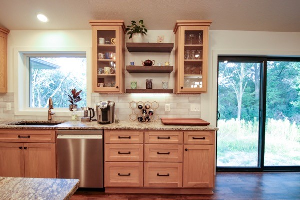 Kitchen shelving spice rack light wood cabinets white backsplash and light counterops