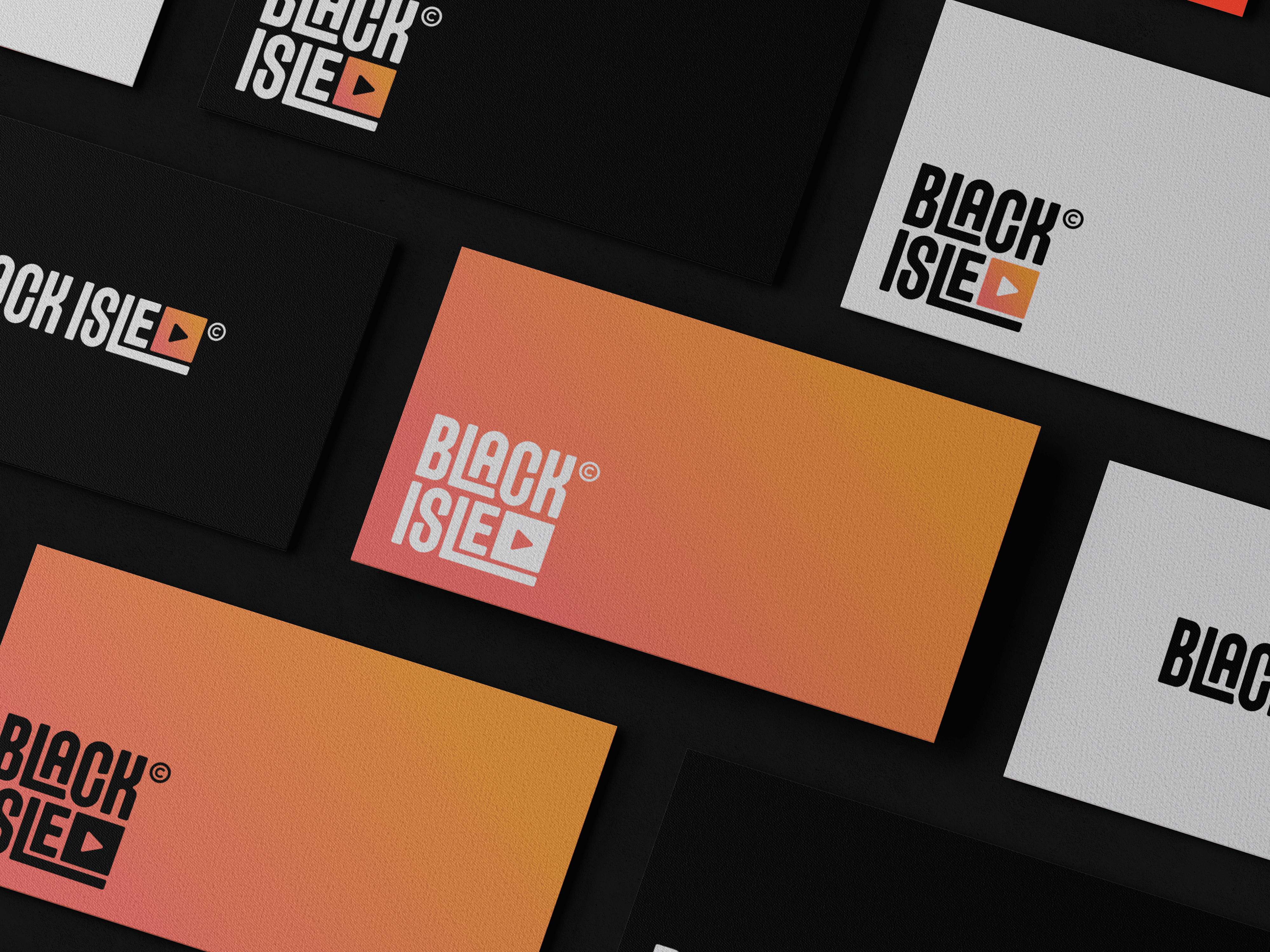 Close up of Black Isle Collective business cards with gradient branding.