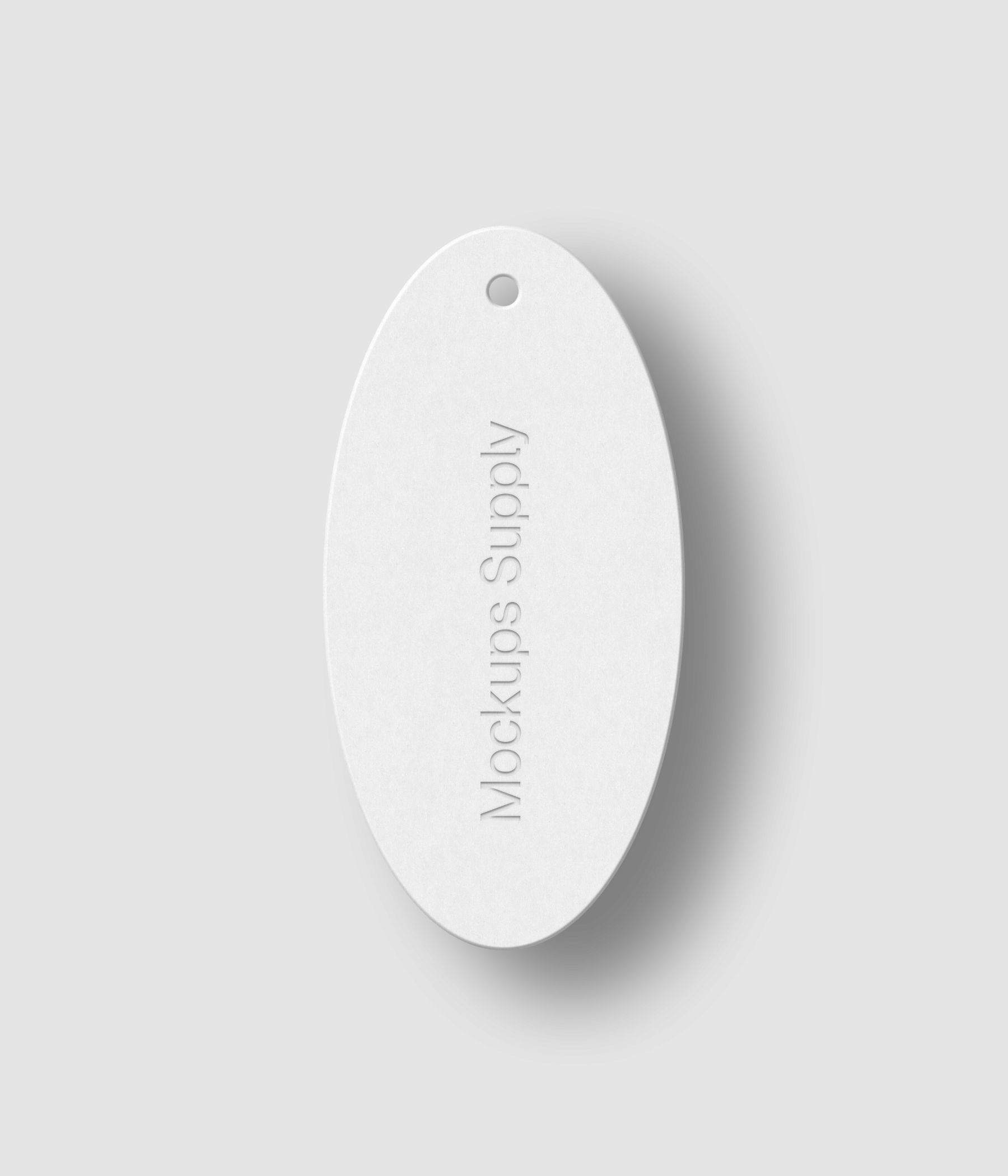 White oval hang tag with debossed text effect and soft shadow on white background photoshop PSD mockup template