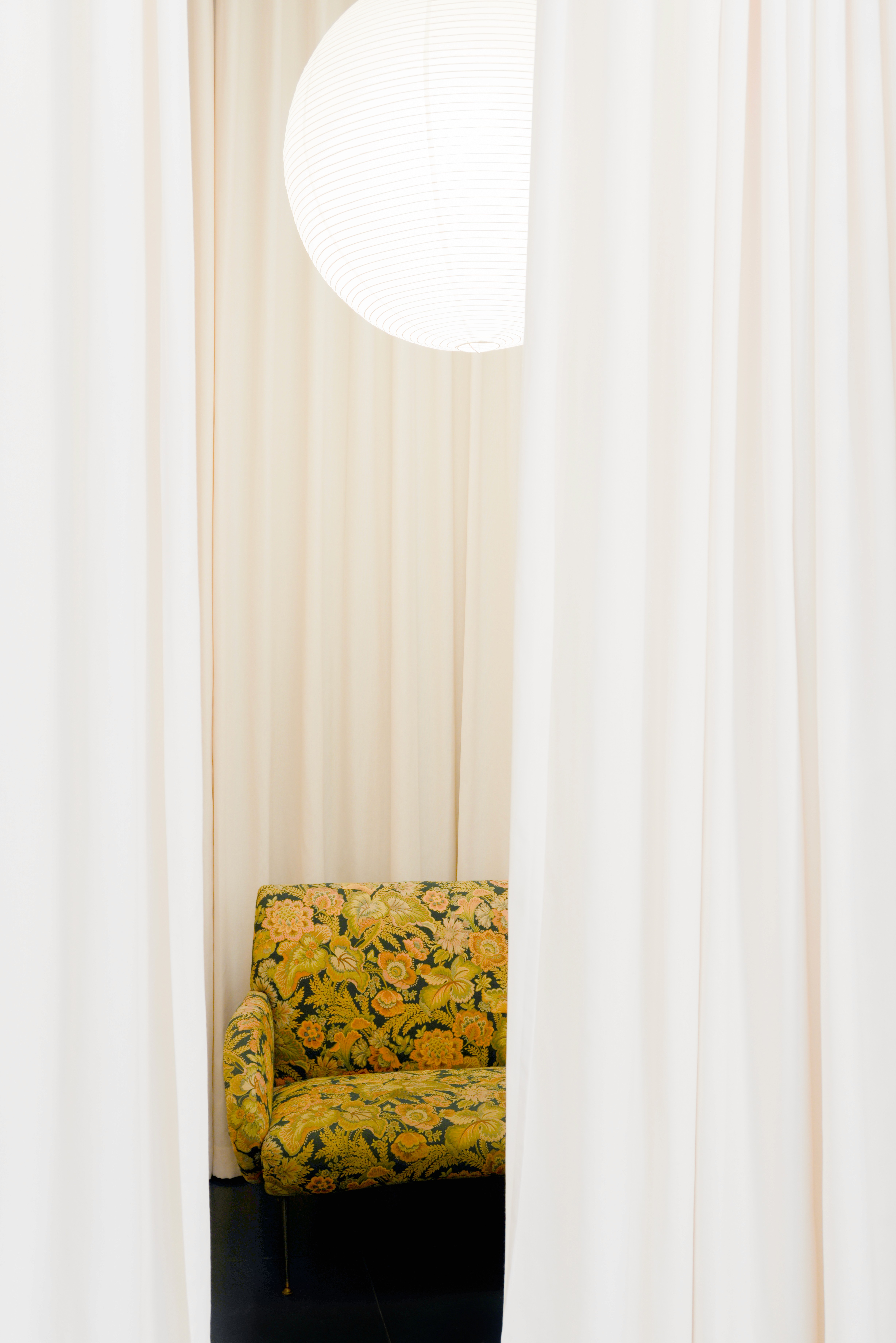 A cozy scene with warm sunlight casting stripes, featuring a potted plant and soft towels on a window sill.