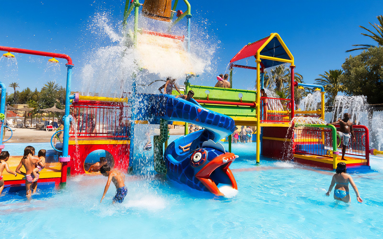 Children playing in colorful water playground at Aquopolis Cullera.