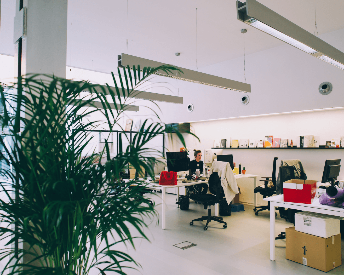  Collaborative work session overhead view of six people collaborating at a rustic wooden table with coffee, papers, and a laptop