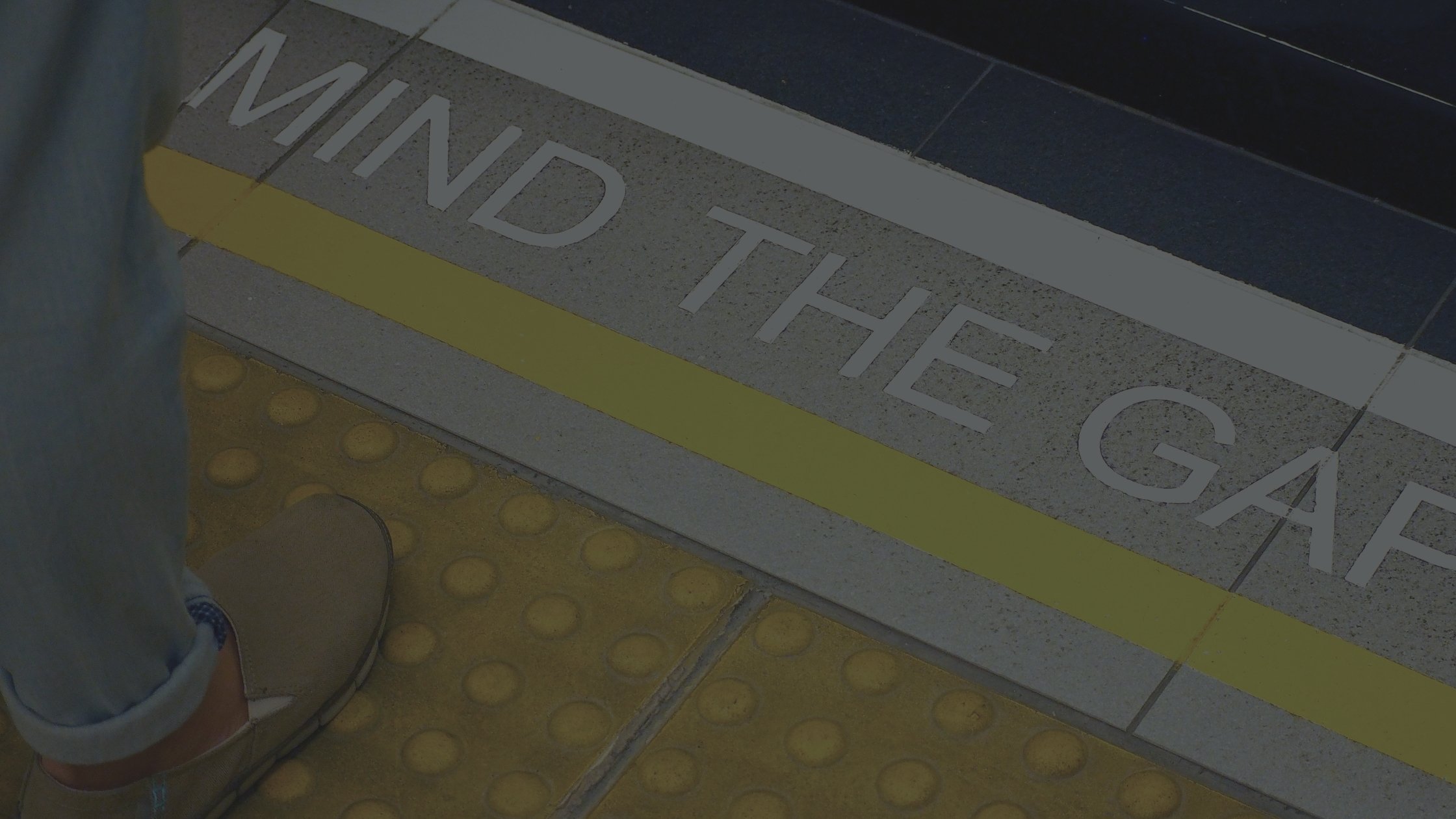 Close-up of Sydney commuter platform with ‘Mind the Gap’ text, representing awareness-to-conversion journey in marketing.