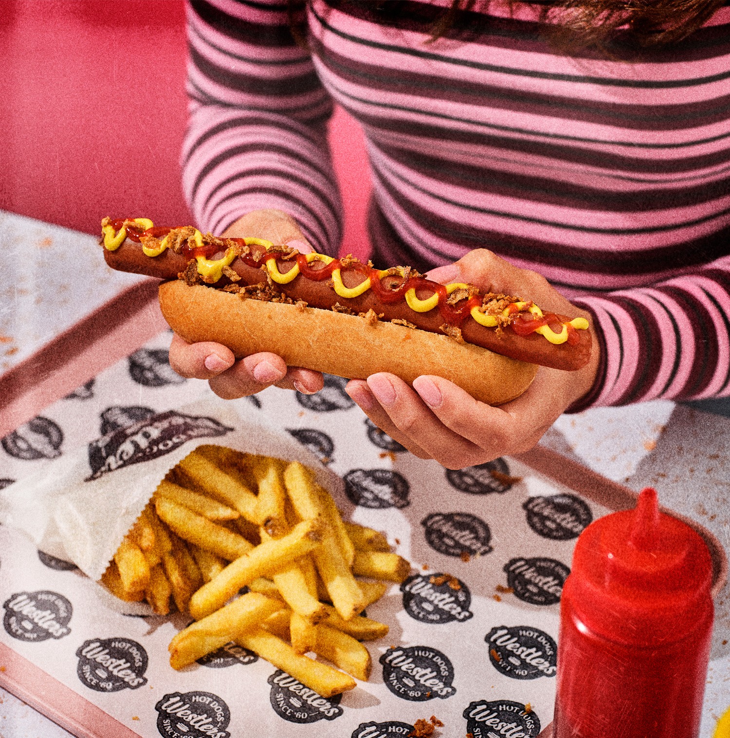 Woman holding large hotdog